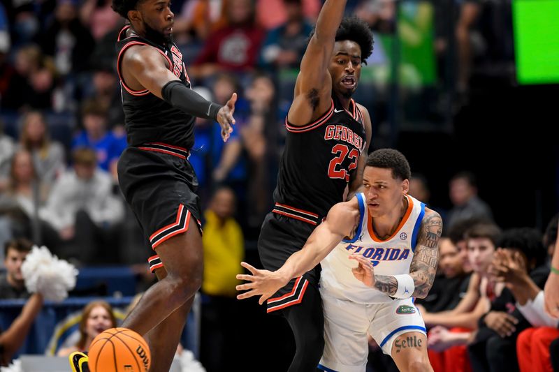 Mar 14, 2024; Nashville, TN, USA;  Florida Gators guard Riley Kugel (2) passes against Georgia Bulldogs forward Jalen DeLoach (23) and during the first half at Bridgestone Arena. Mandatory Credit: Steve Roberts-USA TODAY Sports