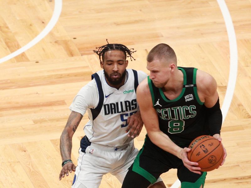 BOSTON, MA - JUNE 9: Derrick Jones Jr. #55 of the Dallas Mavericks plays defense during the game  against Kristaps Porzingis #8 of the Boston Celtics during Game 2 of the 2024 NBA Finals on June 9, 2024 at the TD Garden in Boston, Massachusetts. NOTE TO USER: User expressly acknowledges and agrees that, by downloading and or using this photograph, User is consenting to the terms and conditions of the Getty Images License Agreement. Mandatory Copyright Notice: Copyright 2024 NBAE  (Photo by Chris Marion/NBAE via Getty Images)