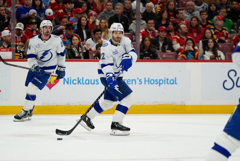 Dec 27, 2025; Sunrise, Florida, USA; Tampa Bay Lightning right wing Oliver Bjorkstrand (22) moves the puck against the Florida Panthers during the first period at Amerant Bank Arena. Mandatory Credit: Jeff Romance-Imagn Images