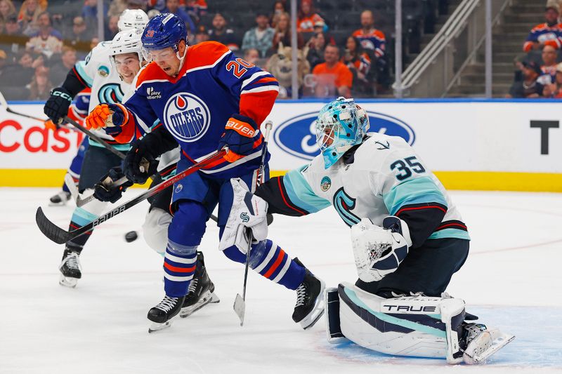 Sep 24, 2025; Edmonton, Alberta, CAN; Edmonton Oilers forward Curtis Lazar (20) tries to deflect a shot on Seattle Kraken goaltender Joey Daccord (35) during the first period at Rogers Place. Mandatory Credit: Perry Nelson-Imagn Images