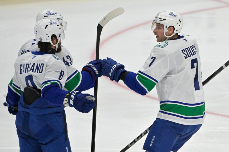 Nov 5, 2024; Anaheim, California, USA; Vancouver Canucks defenseman Quinn Hughes (43) is congratulated by right wing Conor Garland (8) and defenseman Carson Soucy (7) after scoring a goal in the second period against the Anaheim Ducks at Honda Center. Mandatory Credit: Jayne Kamin-Oncea-Imagn Images