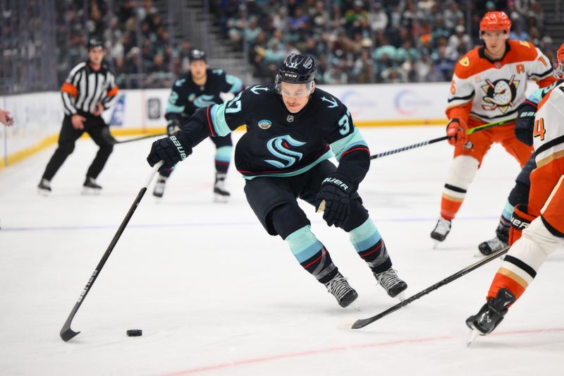 Nov 27, 2024; Seattle, Washington, USA; Seattle Kraken center Yanni Gourde (37) advances the puck against the Anaheim Ducks during the first period at Climate Pledge Arena. Mandatory Credit: Steven Bisig-Imagn Images