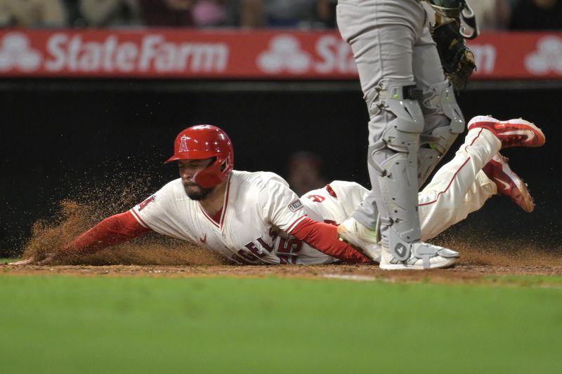 Jun 9, 2025; Anaheim, California, USA;  Los Angeles Angels catcher Travis d'Arnaud (25) scores on a single by Los Angeles Angels center fielder Jo Adell (7) in the eighth inning against the Athletics at Angel Stadium. Mandatory Credit: Jayne Kamin-Oncea-Imagn Images