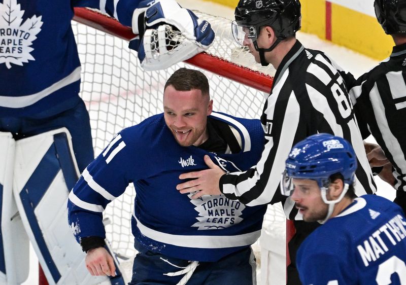 Mar 23, 2024; Toronto, Ontario, CAN; Toronto Maple Leafs forward Max Domi (11) reacts after fighting with Edmonton Oilers forward Mattias Janmark (not shown) in the third period at Scotiabank Arena. Mandatory Credit: Dan Hamilton-USA TODAY Sports