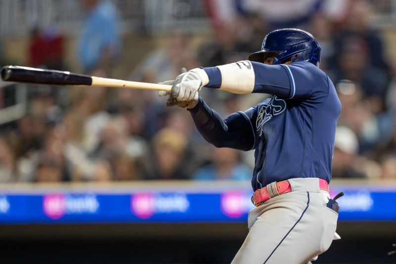 Sep 11, 2023; Minneapolis, Minnesota, USA; Tampa Bay Rays first baseman Yandy Diaz (2) hits a double against the Minnesota Twins in the fourth inning at Target Field. Mandatory Credit: Jesse Johnson-USA TODAY Sports