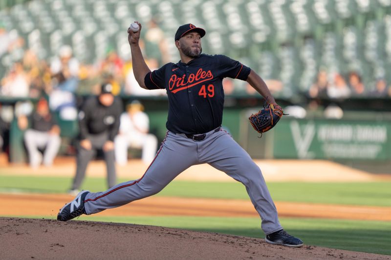 Jul 5, 2024; Oakland, California, USA;  Baltimore Orioles pitcher Albert Suárez (49) pitches during the first inning against the Oakland Athletics at Oakland-Alameda County Coliseum. Mandatory Credit: Stan Szeto-USA TODAY Sports