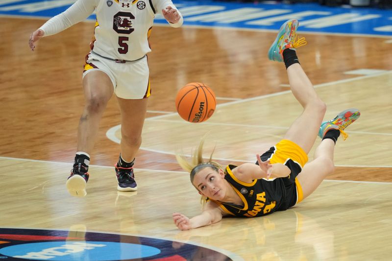 Apr 7, 2024; Cleveland, OH, USA; Iowa Hawkeyes guard Kylie Feuerbach (4) dives for a loose ball against the South Carolina Gamecocks in the finals of the Final Four of the womens 2024 NCAA Tournament at Rocket Mortgage FieldHouse. Mandatory Credit: Aaron Doster-USA TODAY Sports