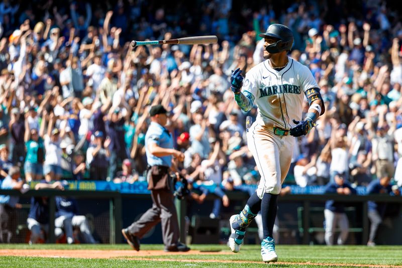 Aug 28, 2024; Seattle, Washington, USA; Seattle Mariners center fielder Julio Rodriguez (44) flips his bat toward the dugout after hitting a two-run home run against the Tampa Bay Rays during the fifth inning at T-Mobile Park. Mandatory Credit: Joe Nicholson-USA TODAY Sports