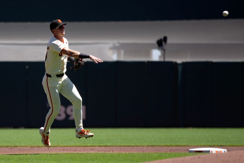 Aug 15, 2024; San Francisco, California, USA; San Francisco Giants shortstop Tyler Fitzgerald (49) leaves his feet to throw and retire Atlanta Braves third baseman Austin Riley (not pictured) at first base during the first inning at Oracle Park. Mandatory Credit: D. Ross Cameron-USA TODAY Sports