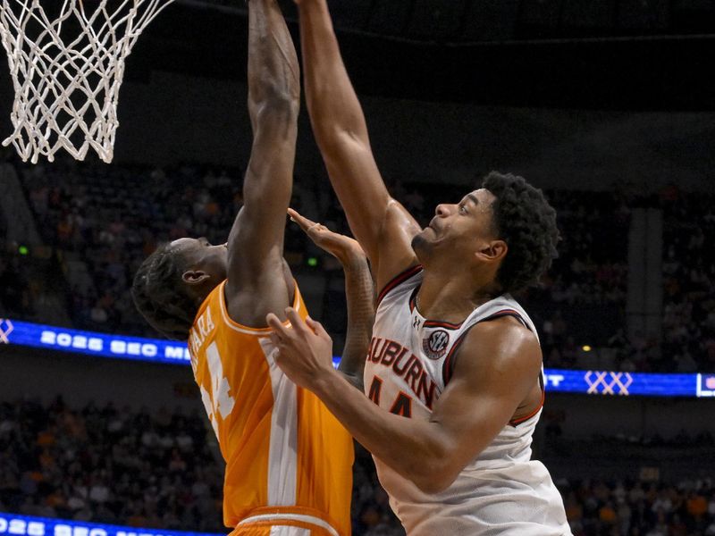 Mar 15, 2025; Nashville, TN, USA;  Tennessee Volunteers forward Felix Okpara (34) blocks the shot of  Auburn Tigers center Dylan Cardwell (44) during the second half at Bridgestone Arena. Mandatory Credit: Steve Roberts-Imagn Images