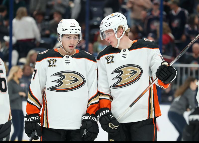 Oct 24, 2023; Columbus, Ohio, USA; Anaheim Ducks right wing Frank Vatrano (77) and defenseman Jackson LaCombe (60) talk during the second period against the Columbus Blue Jackets at Nationwide Arena. Mandatory Credit: Joseph Maiorana-USA TODAY Sports