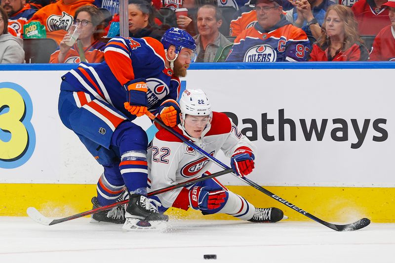 Mar 19, 2024; Edmonton, Alberta, CAN; Edmonton Oilers defensemen Mattias Ekholm (14) and Montreal Canadiens forward Cole Caufield (22) Battle along the boards for a loose puck during the second period at Rogers Place. Mandatory Credit: Perry Nelson-USA TODAY Sports