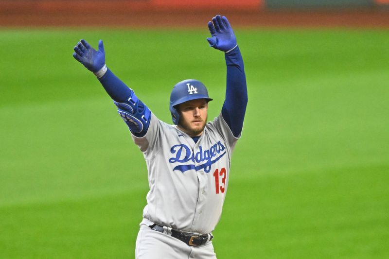 Aug 23, 2023; Cleveland, Ohio, USA; Los Angeles Dodgers designated hitter Max Muncy (13) celebrates his double in the first inning against the Cleveland Guardians at Progressive Field. Mandatory Credit: David Richard-USA TODAY Sports