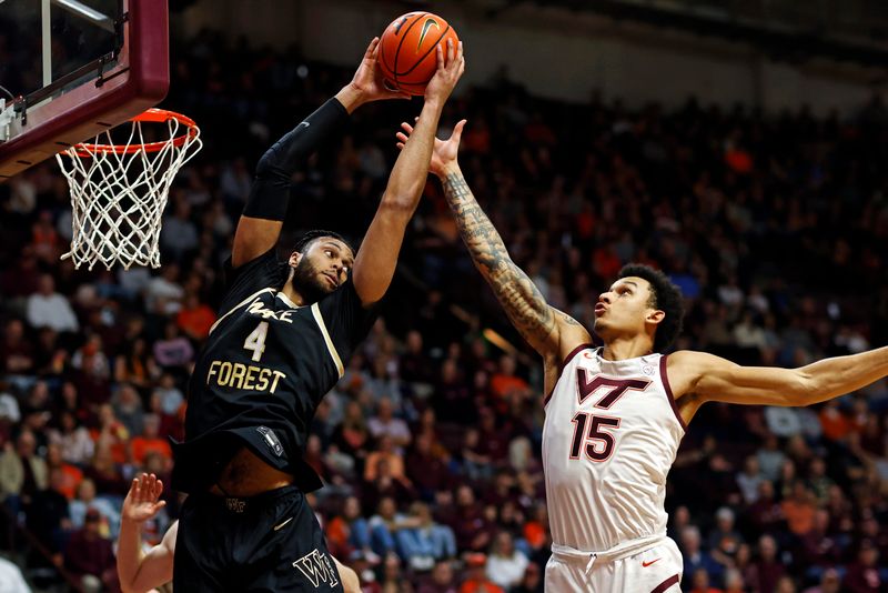 Mar 2, 2024; Blacksburg, Virginia, USA; Wake Forest Demon Deacons forward Efton Reid III (4) grabs a rebound against Virginia Tech Hokies center Lynn Kidd (15) during the first half at Cassell Coliseum. Mandatory Credit: Peter Casey-USA TODAY Sports