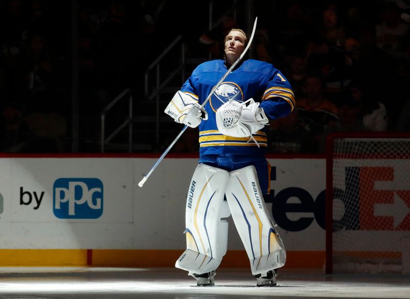 Dec 10, 2022; Pittsburgh, Pennsylvania, USA; Buffalo Sabres goaltender Ukko-Pekka Luukkonen (1) stands for the national anthem against the Pittsburgh Penguins head coach Mike Sullivan () at PPG Paints Arena. Mandatory Credit: Charles LeClaire-USA TODAY Sports