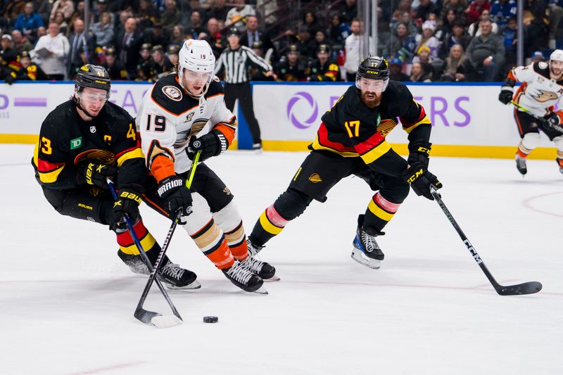 Nov 28, 2023; Vancouver, British Columbia, CAN; Vancouver Canucks defenseman Quinn Hughes (43) and defenseman Filip Hronek (17) battle with Anaheim Ducks forward Troy Terry (19) in the third period at Rogers Arena. Vancouver won 3-1. Mandatory Credit: Bob Frid-USA TODAY Sports