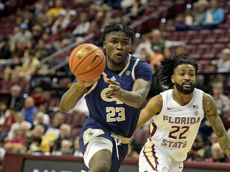 Jan 3, 2024; Tallahassee, Florida, USA; Georgia Tech Yellow Jackets Ibrahima Sacko (23) drives to the net past Florida State Seminoles guard Darin Green Jr. (22) during the first half at Donald L. Tucker Center. Mandatory Credit: Melina Myers-USA TODAY Sports