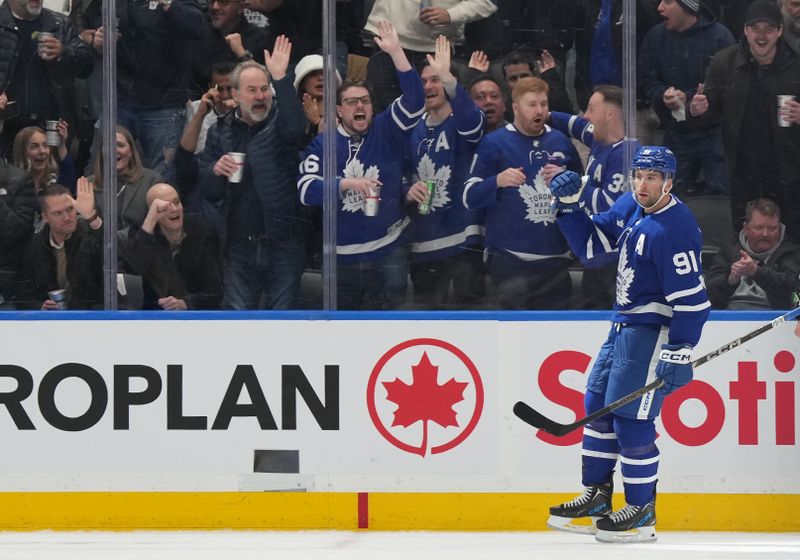 Dec 6, 2024; Toronto, Ontario, CAN; Toronto Maple Leafs center John Tavares (91) celebrates after scoring a goal against the Washington Capitals during the second period at Scotiabank Arena. Mandatory Credit: Nick Turchiaro-Imagn Images