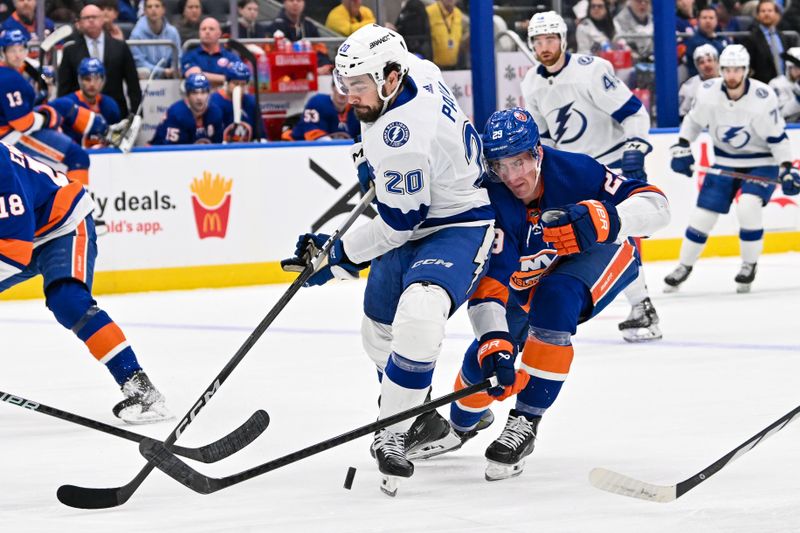 Feb 8, 2024; Elmont, New York, USA; New York Islanders center Brock Nelson (29) defends against Tampa Bay Lightning left wing Nicholas Paul (20) during the first period at UBS Arena. Mandatory Credit: Dennis Schneidler-USA TODAY Sports