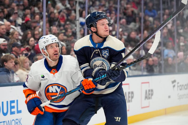 Feb 28, 2026; Columbus, Ohio, USA;  New York Islanders center Casey Cizikas (53) skates against Columbus Blue Jackets left wing Dmitri Voronkov (10) in the third period at Nationwide Arena. Mandatory Credit: Aaron Doster-Imagn Images