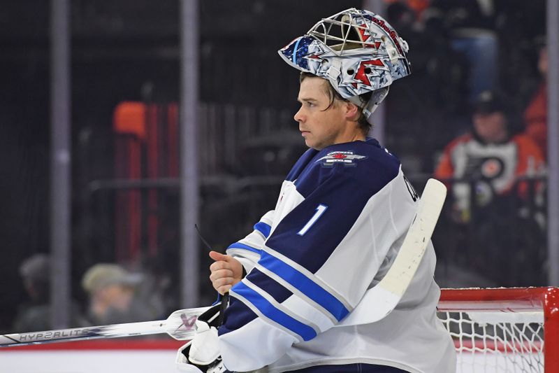 Mar 6, 2025; Philadelphia, Pennsylvania, USA; Winnipeg Jets goaltender Eric Comrie (1) against the Philadelphia Flyers during the third period at Wells Fargo Center. Mandatory Credit: Eric Hartline-Imagn Images