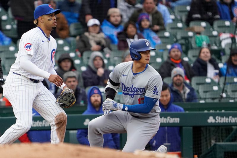 Apr 7, 2024; Chicago, Illinois, USA; Los Angeles Dodgers designated hitter Shohei Ohtani (17) is safe at third base after hitting a as Chicago Cubs third base Christopher Morel (5) stands nearby during the sixth inning at Wrigley Field. Mandatory Credit: David Banks-USA TODAY Sports