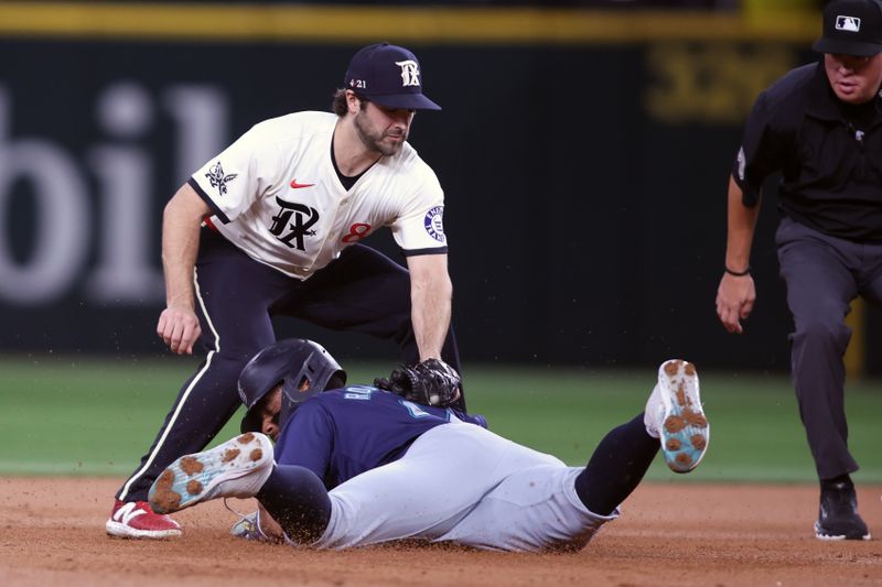 Sep 20, 2024; Arlington, Texas, USA;  Seattle Mariners center fielder Julio Rodríguez (44) dives back to second base as Texas Rangers shortstop Josh Smith (8) applies the tag in the first inning at Globe Life Field. Mandatory Credit: Tim Heitman-Imagn Images