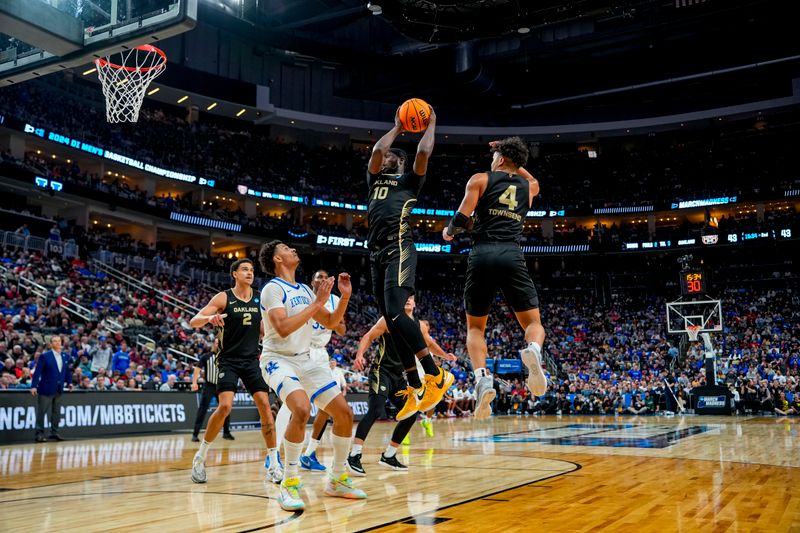 Mar 21, 2024; Pittsburgh, PA, USA; Oakland Golden Grizzlies guard DQ Cole (10) jumps to dunk the ball during the second half  in the first round of the 2024 NCAA Tournament at PPG Paints Arena. Mandatory Credit: Gregory Fisher-USA TODAY Sports