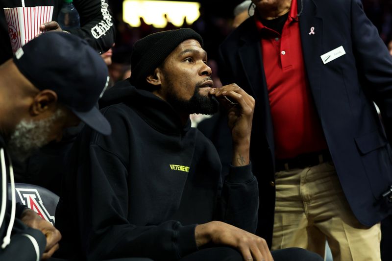 Jan 17, 2024; Tucson, Arizona, USA; Phoenix Suns forward Kevin Durant (center) court side for the game against the Arizona Wildcats and the USC Trojans during the first half at McKale Center. Mandatory Credit: Zachary BonDurant-USA TODAY Sports