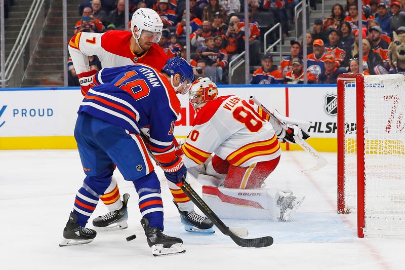 Oct 13, 2024; Edmonton, Alberta, CAN; Edmonton Oilers forward Zach Hyman (18) tries to find a loose puck in front of Calgary Flames goaltender Dan Vladar (80) during the third period at Rogers Place. Mandatory Credit: Perry Nelson-Imagn Images