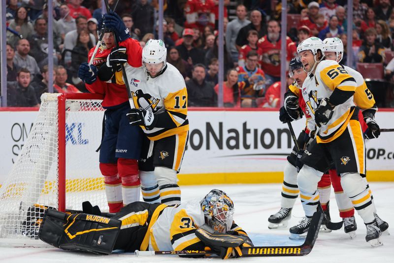 Oct 23, 2025; Sunrise, Florida, USA; Pittsburgh Penguins goaltender Tristan Jarry (35) covers the puck against the Florida Panthers during the second period at Amerant Bank Arena. Mandatory Credit: Sam Navarro-Imagn Images