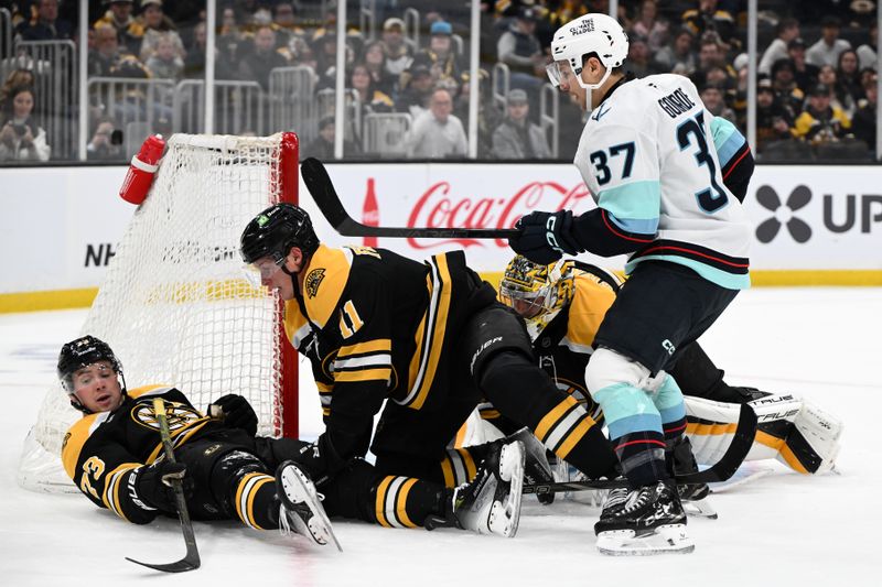 Nov 3, 2024; Boston, Massachusetts, USA; Boston Bruins defenseman Charlie McAvoy (73) and center Trent Frederic (11) block a shot from Seattle Kraken center Yanni Gourde (37) during the second period at the TD Garden. Mandatory Credit: Brian Fluharty-Imagn Images