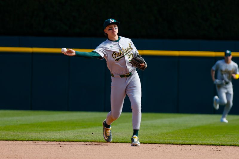 Apr 7, 2024; Detroit, Michigan, USA; Oakland Athletics second base Zack Gelof (20) throws the ball to first during the game against the Detroit Tigers at Comerica Park. Mandatory Credit: Brian Bradshaw Sevald-USA TODAY Sports