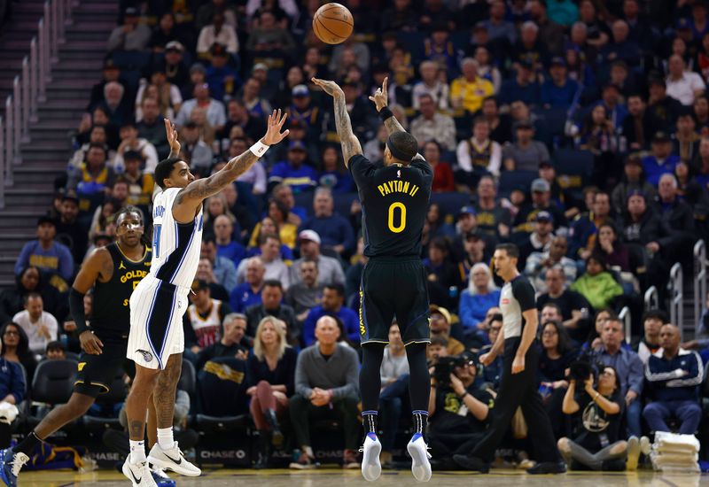 SAN FRANCISCO, CALIFORNIA - FEBRUARY 03:  Gary Payton II #0 of the Golden State Warriors shoots over Gary Harris #14 of the Orlando Magic during the first half of an NBA basketball game at Chase Center on February 03, 2025 in San Francisco, California. NOTE TO USER: User expressly acknowledges and agrees that, by downloading and or using this photograph, User is consenting to the terms and conditions of the Getty Images License Agreement.  (Photo by Thearon W. Henderson/Getty Images)