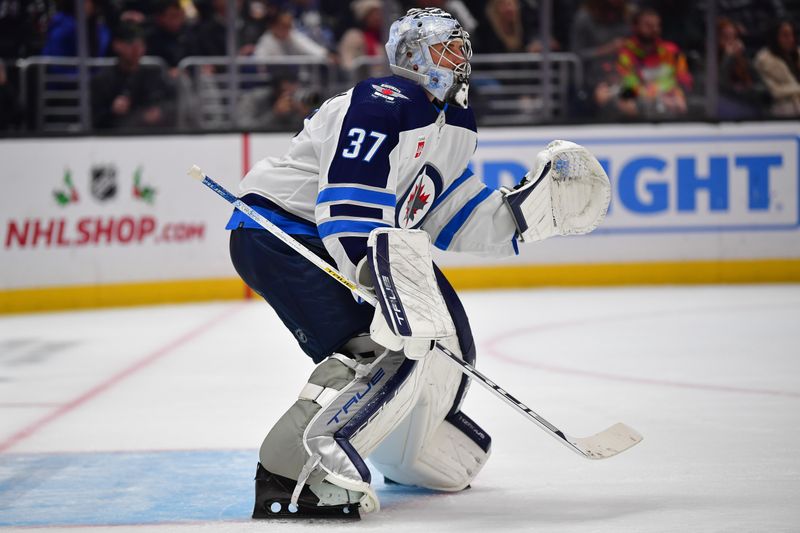 Dec 13, 2023; Los Angeles, California, USA; Winnipeg Jets goaltender Connor Hellebuyck (37) defends the goal against the Los Angeles Kings during the second period at Crypto.com Arena. Mandatory Credit: Gary A. Vasquez-USA TODAY Sports