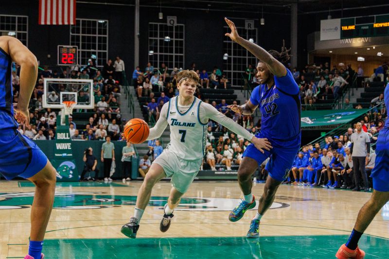 Jan 30, 2025; New Orleans, Louisiana, USA; Tulane Green Wave guard Rowan Brumbaugh (7) drives to the basket against Memphis Tigers forward Dain Dainja (42) during the second half at Avron B. Fogelman Arena in Devlin Fieldhouse. Mandatory Credit: Stephen Lew-Imagn Images