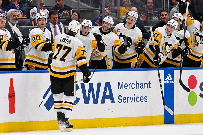 Apr 17, 2024; Elmont, New York, USA;  Pittsburgh Penguins center Jeff Carter (77) celebrates a goal against the New York Islanders with the bench during the third period at UBS Arena. Mandatory Credit: Dennis Schneidler-USA TODAY Sports