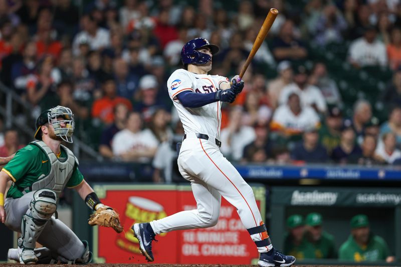 May 16, 2024; Houston, Texas, USA; Houston Astros left fielder Joey Loperfido (10) hits the first home run of his major league career during the third inning against the Oakland Athletics at Minute Maid Park. Mandatory Credit: Troy Taormina-USA TODAY Sports