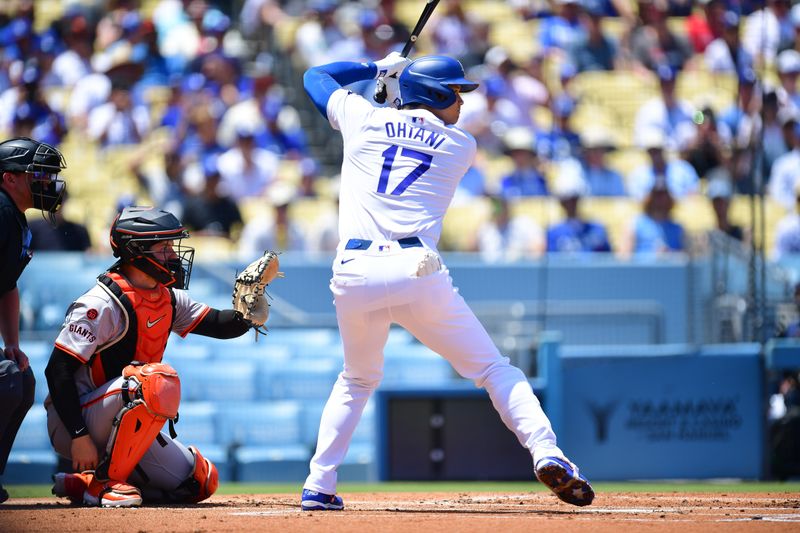 Jul 25, 2024; Los Angeles, California, USA; Los Angeles Dodgers designated hitter Shohei Ohtani (17) hits against the San Francisco Giants during the first inning at Dodger Stadium. Mandatory Credit: Gary A. Vasquez-USA TODAY Sports