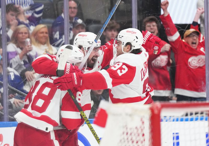 Apr 13, 2024; Toronto, Ontario, CAN; Detroit Red Wings center Dylan Larkin (71) scores the winning goal and celebrates with right wing Alex DeBrincat (93) against the Toronto Maple Leafs during the overtime period at Scotiabank Arena. Mandatory Credit: Nick Turchiaro-USA TODAY Sports