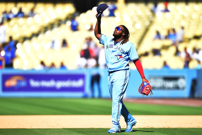 Jul 26, 2023; Los Angeles, California, USA;  Toronto Blue Jays first baseman Vladimir Guerrero Jr. (27) celebrates the victory against the Los Angeles Dodgers at Dodger Stadium. Mandatory Credit: Gary A. Vasquez-USA TODAY Sports