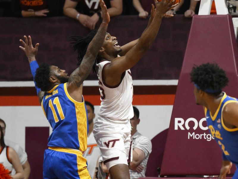 Feb 18, 2023; Blacksburg, Virginia, USA;  Virginia Tech Hokies forward Justyn Mutts (25) drives to basket past Pittsburgh Panthers guard Jamarius Burton (11) at Cassell Coliseum. Mandatory Credit: Lee Luther Jr.-USA TODAY Sports