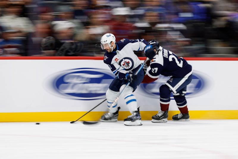 Jan 22, 2025; Denver, Colorado, USA; Winnipeg Jets defenseman Dylan DeMelo (2) and Colorado Avalanche left wing Jonathan Drouin (27) battle for the puck in the second period at Ball Arena. Mandatory Credit: Isaiah J. Downing-Imagn Images