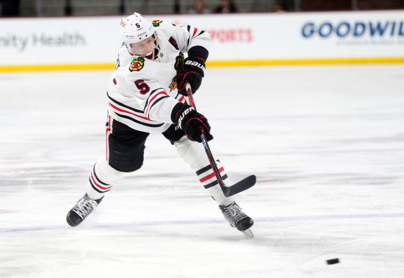 Mar 18, 2023; Tempe, Arizona, USA; Chicago Blackhawks defenseman Connor Murphy (5) shoots against the Arizona Coyotes during the first period at Mullett Arena. Mandatory Credit: Joe Camporeale-USA TODAY Sports