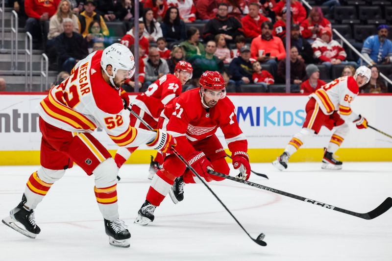 Oct 22, 2023; Detroit, Michigan, USA;  Calgary Flames defenseman MacKenzie Weegar (52) passes while being defended by Detroit Red Wings center Dylan Larkin (71) in the second period at Little Caesars Arena. Mandatory Credit: Rick Osentoski-USA TODAY Sports