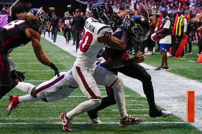 Atlanta Falcons quarterback Desmond Ridder (9) scores a touchdown against Houston Texans cornerback Ka'dar Hollman (20) in the first half of an NFL football game in Atlanta, Sunday, Oct. 8, 2023. (AP Photo/John Bazemore)