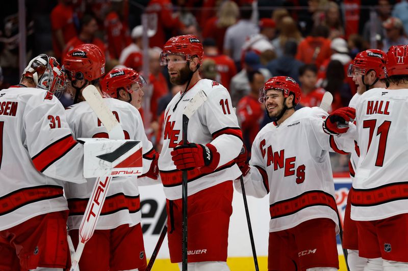 May 15, 2025; Washington, District of Columbia, USA; Carolina Hurricanes players celebrate after their series clinching win against the Washington Capitals in game five of the second round of the 2025 Stanley Cup Playoffs at Capital One Arena. Mandatory Credit: Geoff Burke-Imagn Images