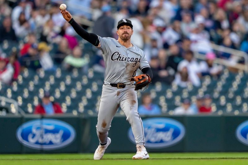 Apr 22, 2024; Minneapolis, Minnesota, USA; Chicago White Sox third baseman Danny Mendick (0) throws the ball to first base for an out against the Minnesota Twins in the fourth inning at Target Field. Mandatory Credit: Jesse Johnson-USA TODAY Sports