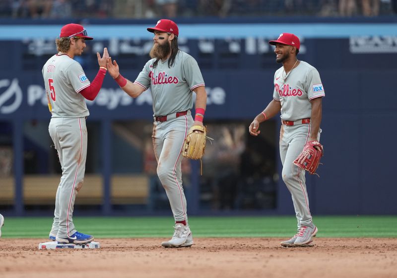 Sep 4, 2024; Toronto, Ontario, CAN; Philadelphia Phillies left fielder Brandon Marsh (16) celebrates the win with Philadelphia Phillies second baseman Bryson Stott (5) against the Toronto Blue Jays at the end of the ninth inning at Rogers Centre. Mandatory Credit: Nick Turchiaro-Imagn Images