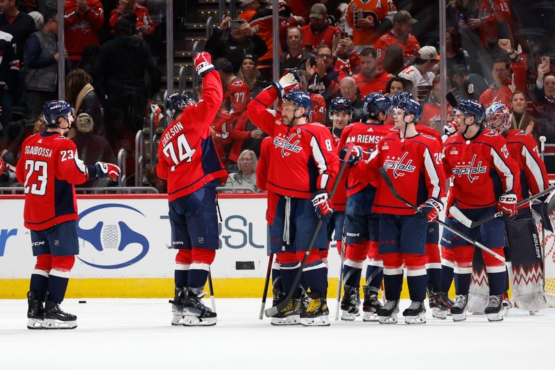 Mar 1, 2024; Washington, District of Columbia, USA; Washington Capitals players celebrate after their game against the Philadelphia Flyers at Capital One Arena. Mandatory Credit: Geoff Burke-USA TODAY Sports